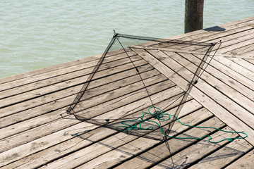 rectangular fish net on a wooden deck