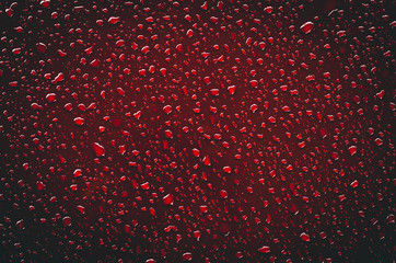 Water drops on red Surface from Parts of the car after rain