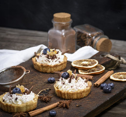 sweet cakes with white cream and chocolate powder