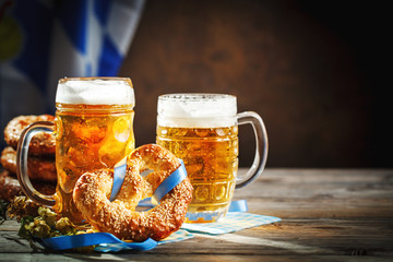 Beer mugs and pretzels on a wooden table. Oktoberfest. Beer festival.