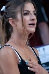 Close-up of a beautiful blonde girl's face, with expression of surprise. Model with fashionable clothes in a performance of fashionable young clothes.