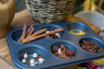 Variety of spices and herbs on kitchen table.