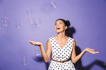 Portrait of a delighted young woman in summer dress