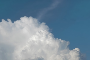 white fluffy clouds on blue clear sky in summer