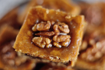 appetizing baklava with nuts and honey closeup on a wooden background