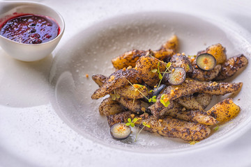 delicious sweet poppy gnocchi or pasta with blueberries sauce served on white plate, dessert product photography