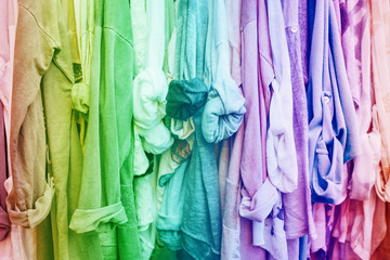 Rainbow background with jersey woman's clothes in shop.