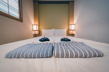 Japanese yukata and towel on bedroom in hotel, Tokyo, Japan. Vintage tone. Selective focus