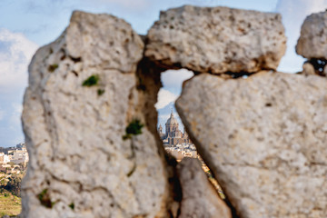 Neolithic megalith temple complex of Ggantija (Tempji Neolitici Tal-Ggantija, Giant Tower) on Gozo island in Malta. Church is visible in gap between stones. UNESCO World Heritage Site.