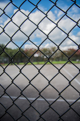Fototapeta premium Outdoor basketball Court through Fence 