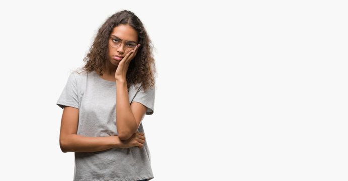 Beautiful young hispanic woman wearing glasses thinking looking tired and bored with depression problems with crossed arms.
