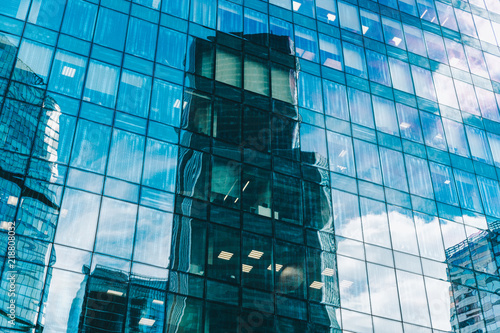 Clouds And Skyscrapers Are Reflected In The Windows Of The