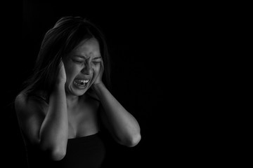Women shouts covered his on a black background. Stressed women. Women shouting on black background. Space for text. sad and unhappy women. Problem women violence against...