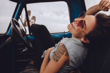 Woman on road trip relaxing in car