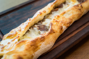 Turkish Bafra Pide with Minced Meat Kavurma Salad and Pickles.