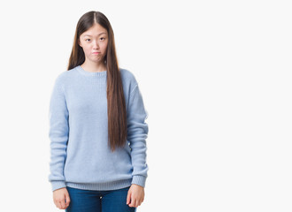 Fototapeta premium Young Chinese woman over isolated background depressed and worry for distress, crying angry and afraid. Sad expression.