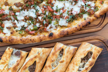 Turkish Bafra Pide with Minced Meat Kavurma Salad and Pickles.