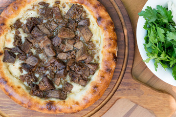 Turkish Round Pide with Meat Kavurma and Cheese.