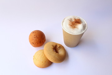 Take away capuccino coffee with some traditional colombian pastries, usually served for breakfast. Almojabana, buñuelo and pandebono.