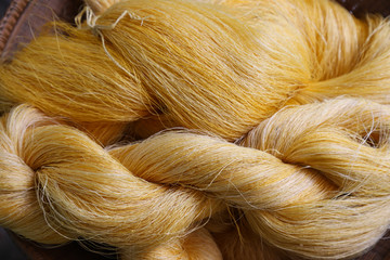 Closeup of Thai silk rolls in bamboo basket.