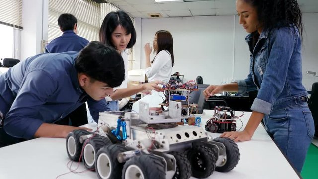 Teenager engineer develop robot at laboratory. People with technology or innovation concept. 4K Resolution.