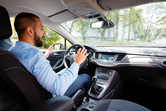 Side view of surprised man in a self-driving car