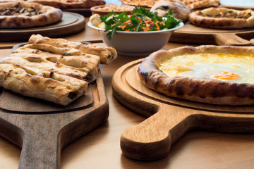 Variety of Turkish Pide Traditional food with beef, Cheese, Fried Egg and Salad.