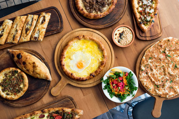 Variety of Turkish Pide Traditional food with beef, Cheese, Fried Egg and Salad.