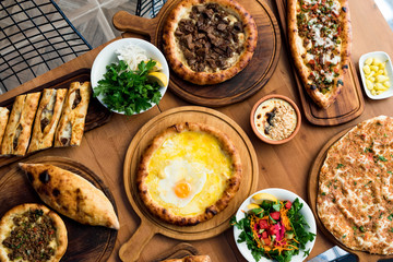 Variety of Turkish Pide Traditional food with beef, Cheese, Fried Egg and Salad.