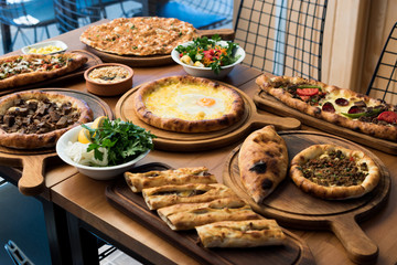 Variety of Turkish Pide Traditional food with beef, Cheese, Fried Egg and Salad.