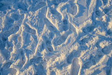 messy footprints of human shoes on the snow