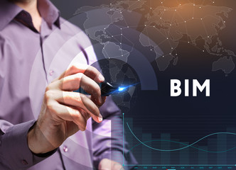 The concept of business, technology, the Internet and the network. A young entrepreneur working on a virtual screen of the future and sees the inscription: BIM