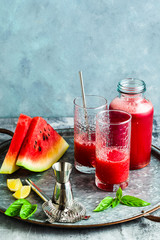 Freshly squeezed juice from a watermelon on a table in glasses. Preparation of a cocktail or a non-alcoholic drink. Healthy Eating and Fruitarianism