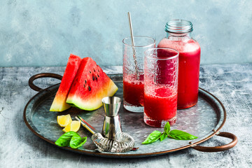 Freshly squeezed juice from a watermelon on a table in glasses. Preparation of a cocktail or a non-alcoholic drink. Healthy Eating and Fruitarianism