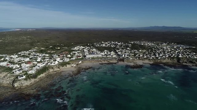 Aerial footage over the small holiday and fishing village of Arniston along the overberg coastline in South Africa