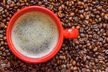 a cup of coffee on a background of coffee beans