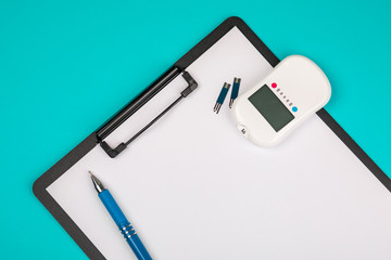 Document, record data from glucometers to medical forms, the result of the sugar measurement, concept of measurement of blood sugar. On a blue background