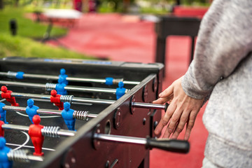 close up table soccer foosball with defocused background. a having fun concept