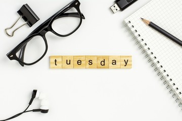 wooden alphabet words "tuesday" on white office desk.  - for business concept background.