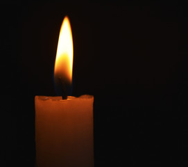 Single lit candle with quite flame