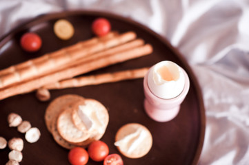Freah breakfast with eggs, tomatoes and cheese on wooden tray. Good morning.