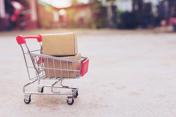 Shopping concept : Cartons or Paper boxes in shopping cart on concrete floor. online shopping...