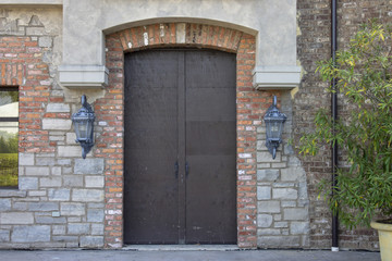 Fototapeta na wymiar Large Exterior Doorway Against Stone and Brick Wall