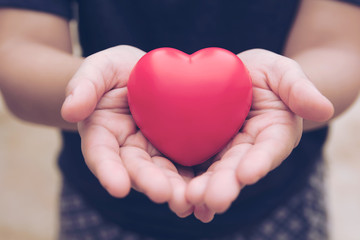 Red heart ball : Stress reliever foam ball the red heart shape on woman hand. Gift valentine's Day