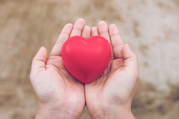 Red heart ball : Stress reliever foam ball the red heart shape on woman hand. Gift valentine's Day