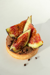 Florence, Tuscany / Italy-2018, Augst 19.  chocolate cake with figs and honey, decorated with gold pieces, Haute cuisine in an Italian restaurant, gourmet dessert. cake on white background, isolated