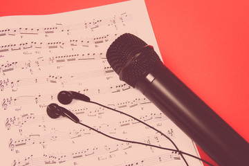 Microphone on music sheets. The concept of creating music.