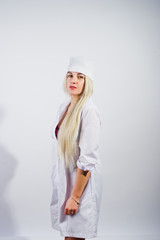 Attractive blonde female doctor or nurse  in lab coat isolated on white background.