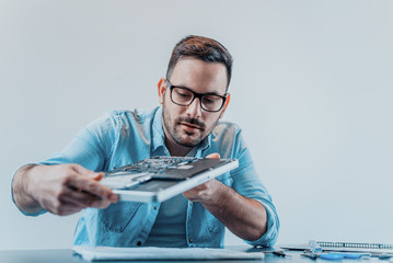 Handsome technician working on repairing hardware
