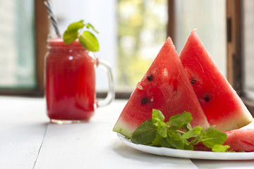 Tasty fresh appetizing watermelon drink smoothie with mint on white table